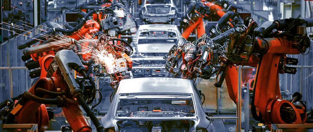 Line of automated welding robots in automotive plant dealing with semiconductor automotive shortage