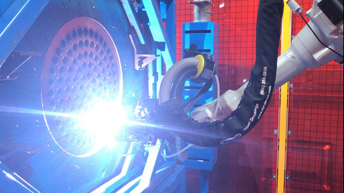 Robotic arm operating in robotic welding cells