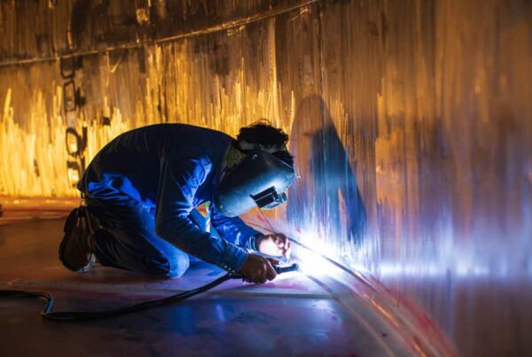 A welder uses GTAW welding to finish up a seam in a stainless steel tank interior