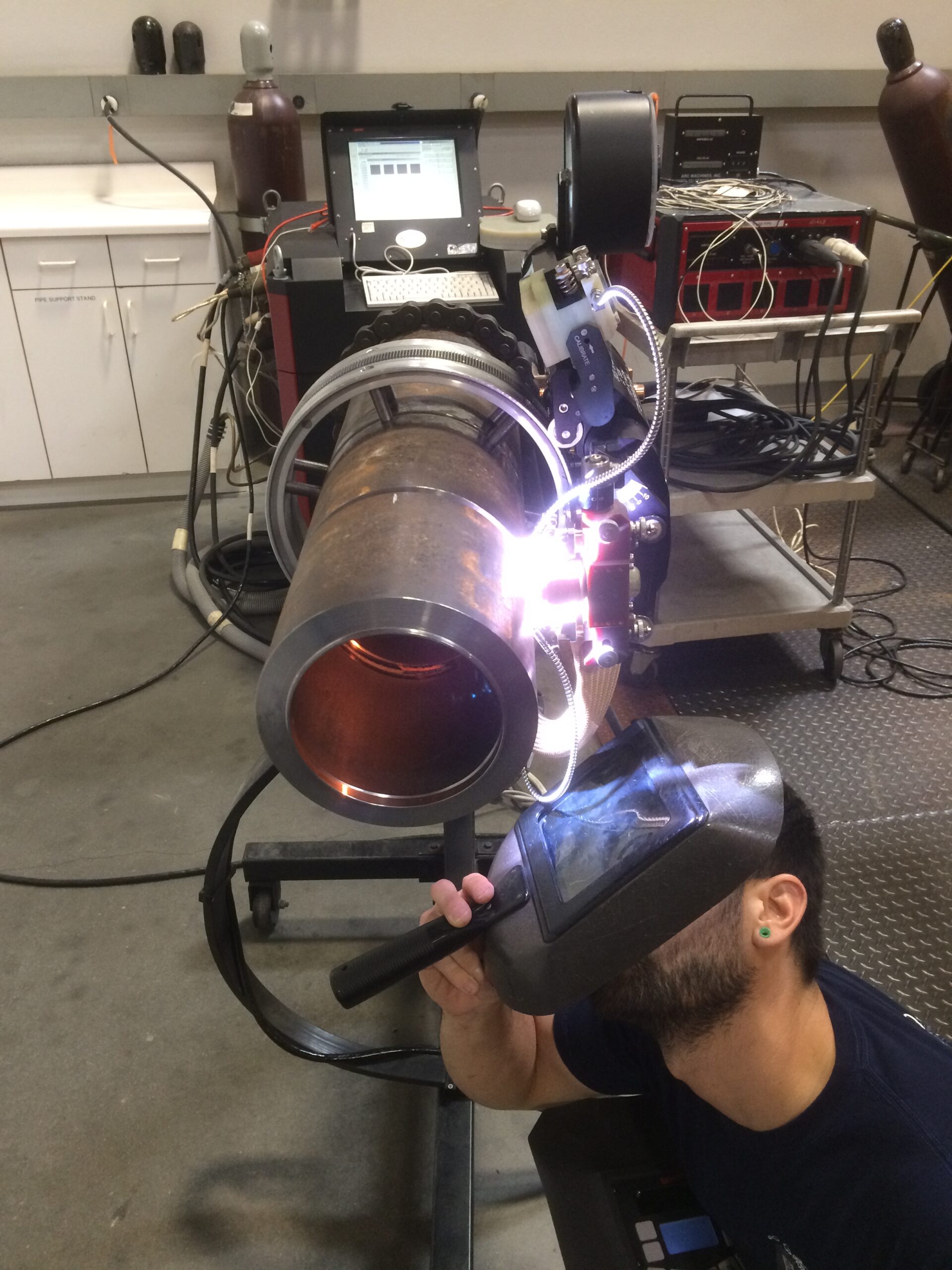 An image of an orbital TIG welding system includes a power supply, weld head, and add-ons like sensors and cooling systems
